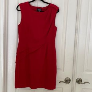 Sleeveless red sheath with shoulder and waist details.